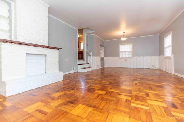 6785 Marvin Ave, North College Hill, OH 45224 - unfurnished living room featuring a wainscoted wall, crown molding, and stairs