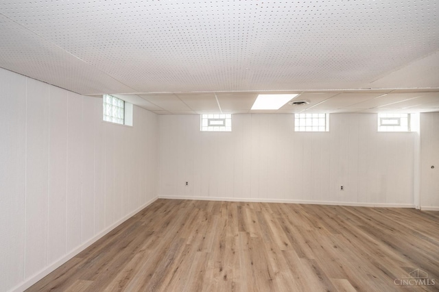 6290 Ludlum Rd, Salem Twp, OH 45152 - below grade area featuring light wood finished floors, a drop ceiling, and baseboards