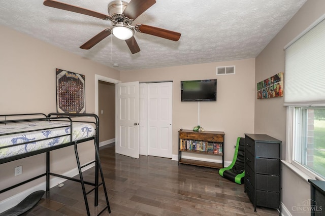 6290 Ludlum Rd, Salem Twp, OH 45152 - bedroom with a textured ceiling, wood finished floors, baseboards, a closet, and a ceiling fan