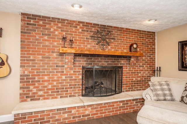 6290 Ludlum Rd, Salem Twp, OH 45152 - living area with wood finished floors, a textured ceiling, and a brick fireplace