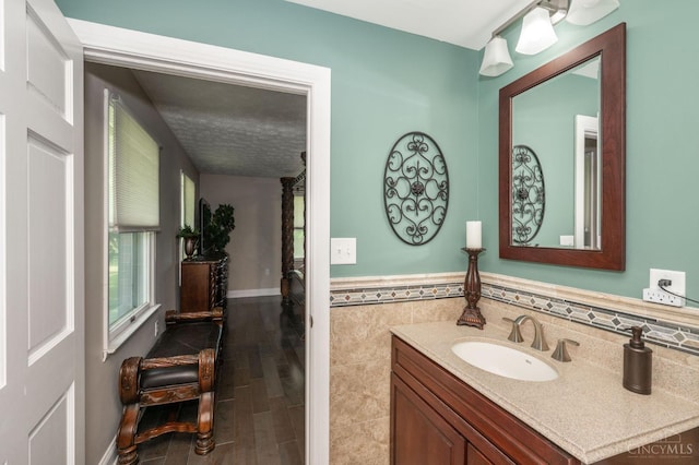 6290 Ludlum Rd, Salem Twp, OH 45152 - bathroom with vanity, tile walls, a wainscoted wall, and wood finished floors
