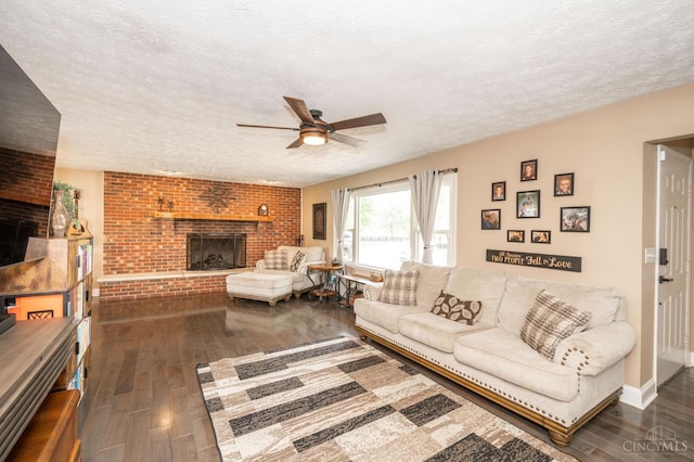 6290 Ludlum Rd, Salem Twp, OH 45152 - living area featuring dark wood-type flooring, a fireplace, a ceiling fan, and a textured ceiling