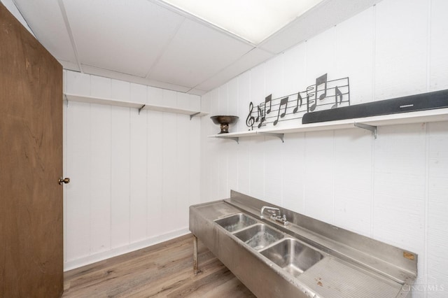 6290 Ludlum Rd, Salem Twp, OH 45152 - kitchen featuring wood finished floors, open shelves, a breakfast bar, and a sink
