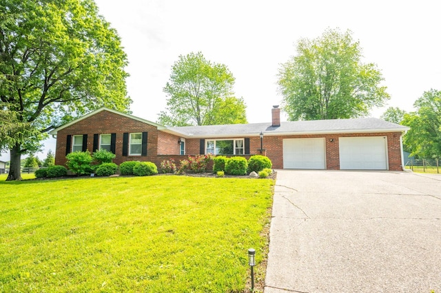 6290 Ludlum Rd, Salem Twp, OH 45152 - ranch-style home with an attached garage, brick siding, concrete driveway, and a front lawn