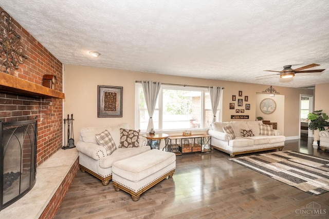 6290 Ludlum Rd, Salem Twp, OH 45152 - living room featuring wood finished floors, a textured ceiling, ceiling fan, and a fireplace