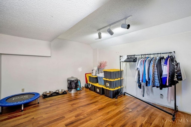 4723 Rosedale Rd, Middletown, OH 45042 - miscellaneous room with wood finished floors, track lighting, and a textured ceiling