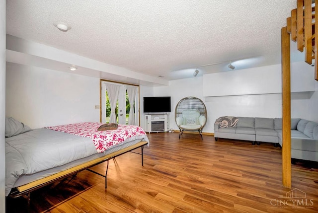 4723 Rosedale Rd, Middletown, OH 45042 - bedroom with a textured ceiling, access to exterior, and wood finished floors