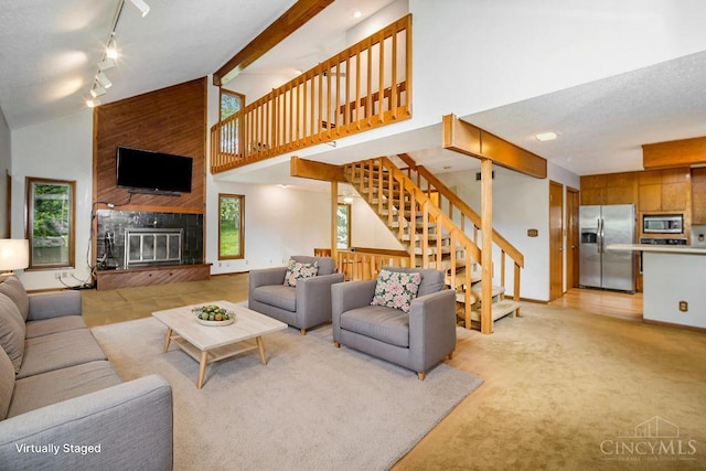 4723 Rosedale Rd, Middletown, OH 45042 - living area featuring stairway, healthy amount of natural light, high vaulted ceiling, track lighting, and a large fireplace