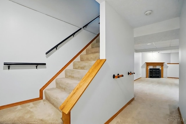 6872 Sandharbor Ct, Hamilton Twp, OH 45039 - staircase featuring carpet, baseboards, and a fireplace