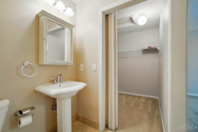 6872 Sandharbor Ct, Hamilton Twp, OH 45039 - bathroom featuring toilet, baseboards, a sink, and a walk in closet