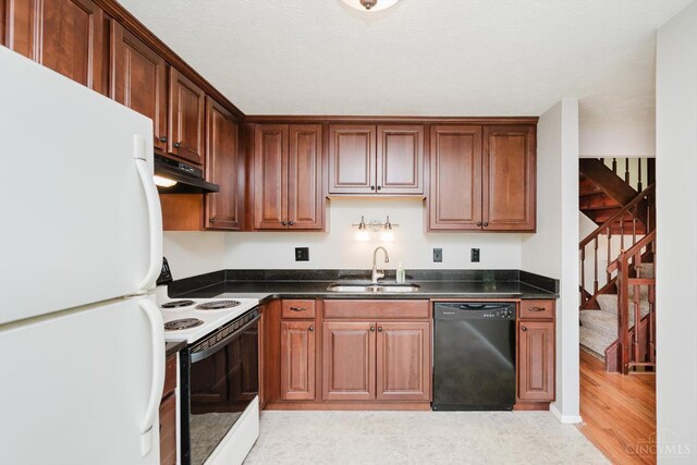 4634 Courtwood Cir, Union Twp, OH 45103 - kitchen featuring white appliances, a sink, dark countertops, under cabinet range hood, and light wood-style floors