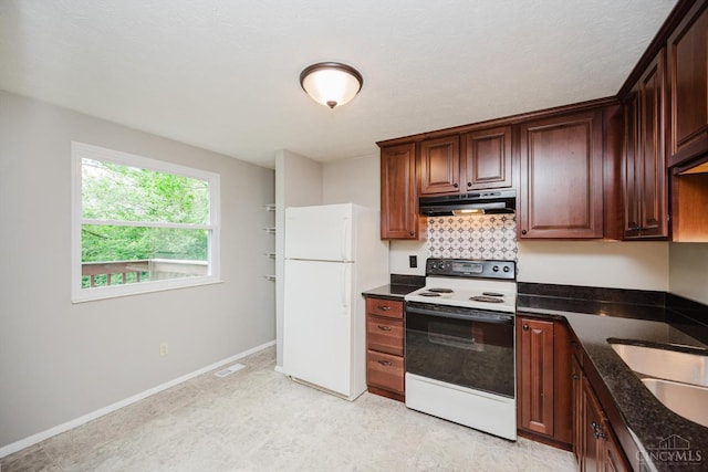 4634 Courtwood Cir, Union Twp, OH 45103 - kitchen featuring range with electric cooktop, under cabinet range hood, freestanding refrigerator, tasteful backsplash, and dark stone countertops