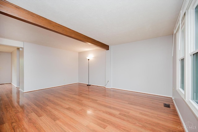 4634 Courtwood Cir, Union Twp, OH 45103 - empty room featuring wood finished floors, beam ceiling, and baseboards