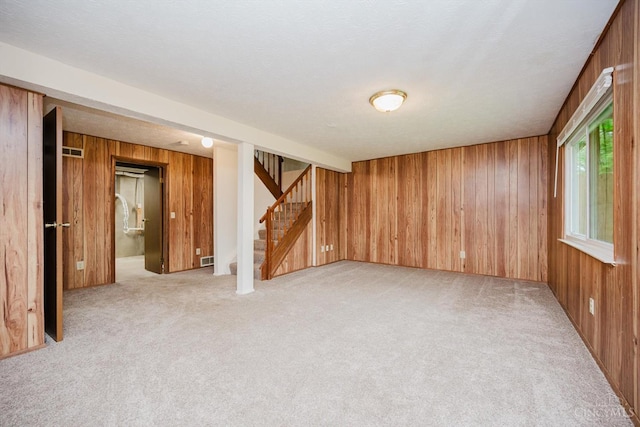 4634 Courtwood Cir, Union Twp, OH 45103 - below grade area with wooden walls, light colored carpet, and stairs