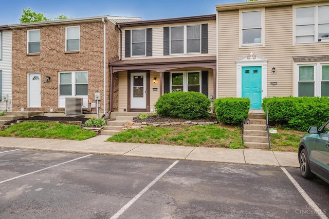 4634 Courtwood Cir, Union Twp, OH 45103 - view of property featuring uncovered parking, central AC, and brick siding