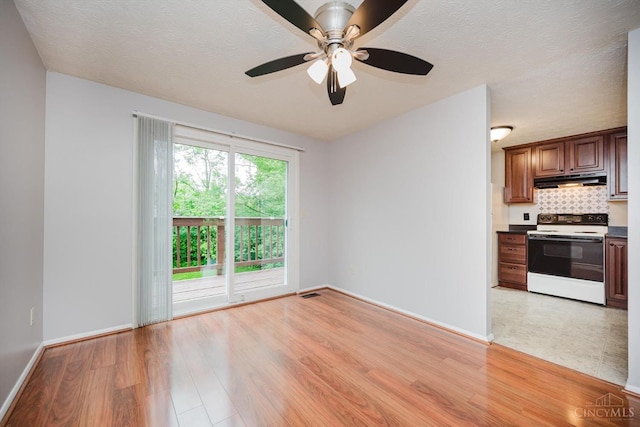 4634 Courtwood Cir, Union Twp, OH 45103 - unfurnished living room with light wood-style flooring, a ceiling fan, baseboards, and a textured ceiling