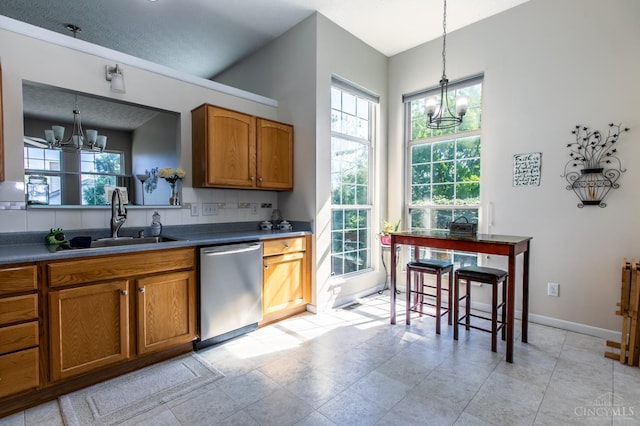 6260 Lake Front, Mason, OH 45040 - kitchen featuring a chandelier, stainless steel dishwasher, a sink, and brown cabinetry