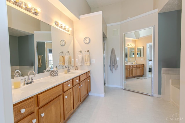6260 Lake Front, Mason, OH 45040 - bathroom featuring double vanity, a bath, baseboards, and ensuite bath