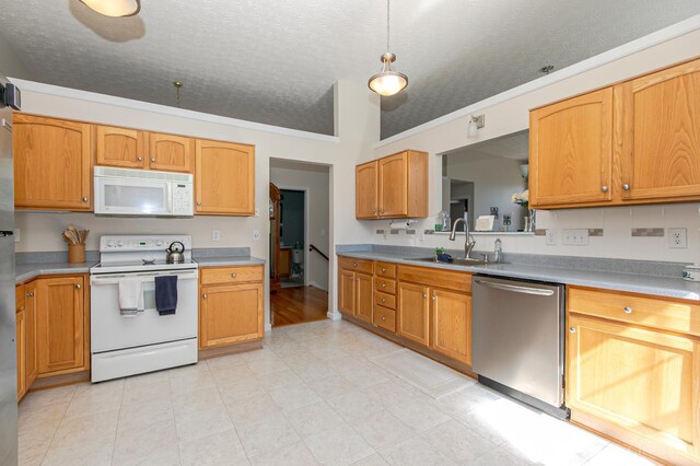 6260 Lake Front, Mason, OH 45040 - kitchen featuring white appliances, a sink, light countertops, a textured ceiling, and crown molding