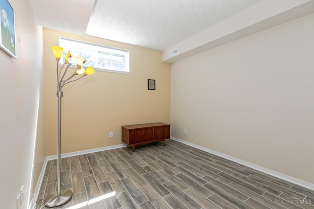 6260 Lake Front, Mason, OH 45040 - unfurnished room with dark wood-style floors, baseboards, and a textured ceiling
