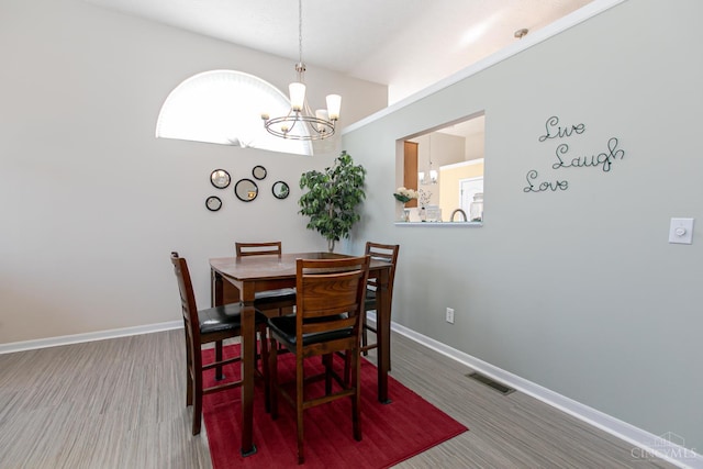 6260 Lake Front, Mason, OH 45040 - dining room with a chandelier, baseboards, and wood finished floors