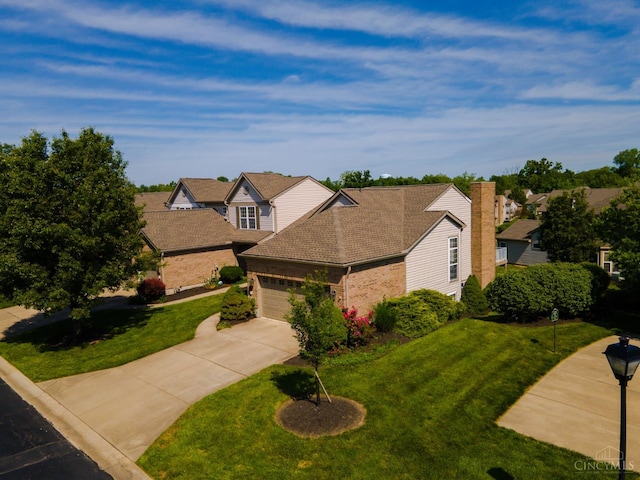 6260 Lake Front, Mason, OH 45040 - traditional-style house with brick siding, concrete driveway, a front lawn, an attached garage, and roof with shingles