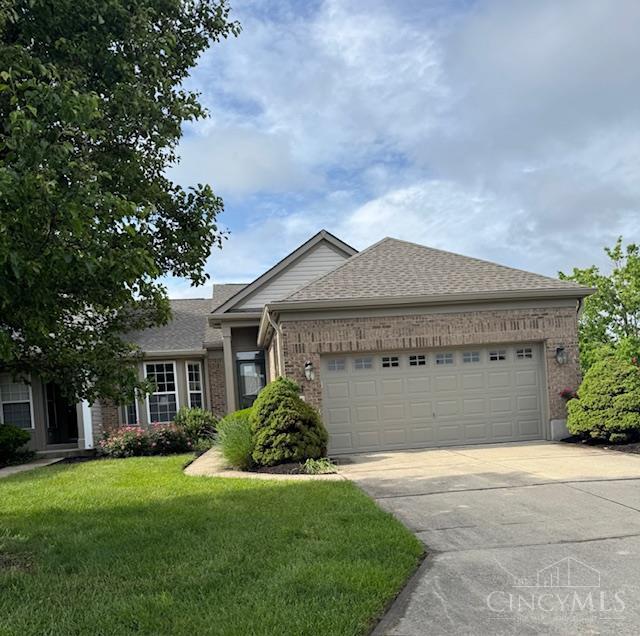 6260 Lake Front, Mason, OH 45040 - ranch-style home with brick siding, a garage, a front lawn, concrete driveway, and a shingled roof