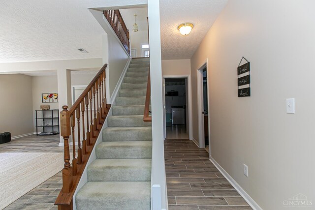 6260 Lake Front, Mason, OH 45040 - stairway with wood finished floors, a textured ceiling, and baseboards