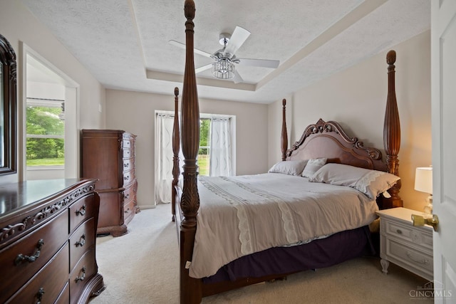 2489 Swings Corner Pt Isabel Rd, Tate Twp, OH 45106 - bedroom featuring light carpet, multiple windows, a textured ceiling, a tray ceiling, and a ceiling fan