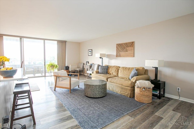 2324 Madison Rd Unit 506, Cincinnati, OH 45208 - living area with wood finished floors, expansive windows, and baseboards