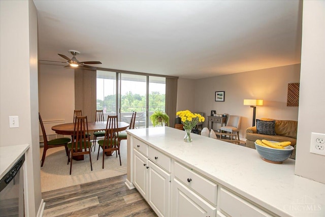 2324 Madison Rd Unit 506, Cincinnati, OH 45208 - kitchen with dark wood-style floors, white cabinets, dishwasher, open floor plan, and ceiling fan