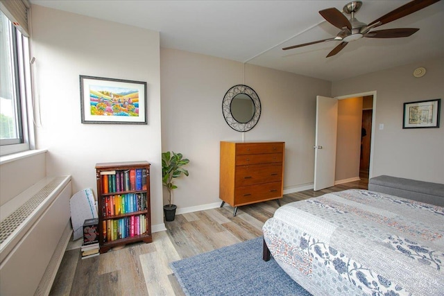 2324 Madison Rd Unit 506, Cincinnati, OH 45208 - bedroom featuring wood finished floors, radiator heating unit, baseboards, and a ceiling fan