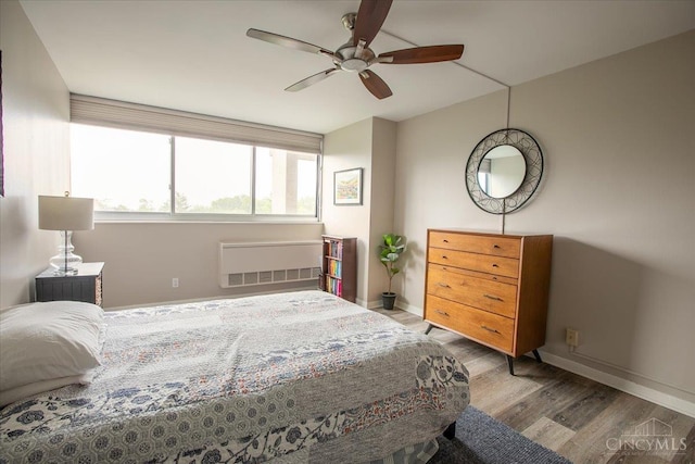 2324 Madison Rd Unit 506, Cincinnati, OH 45208 - bedroom with radiator heating unit, wood finished floors, baseboards, and a ceiling fan