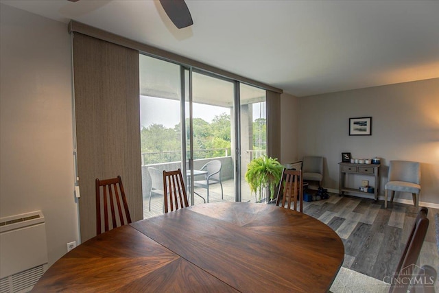 2324 Madison Rd Unit 506, Cincinnati, OH 45208 - dining space with wood finished floors, a wall of windows, baseboards, and ceiling fan