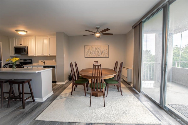 2324 Madison Rd Unit 506, Cincinnati, OH 45208 - dining room with wood finished floors, ceiling fan, and baseboards