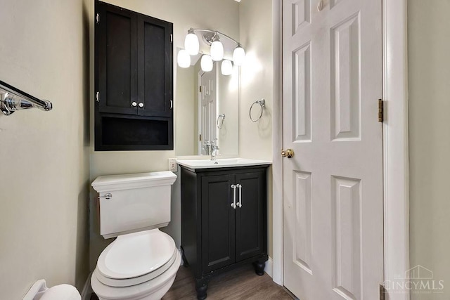 8714 Wuest Rd, Colerain Twp, OH 45251 - bathroom featuring toilet, vanity, and wood finished floors