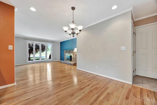 8714 Wuest Rd, Colerain Twp, OH 45251 - unfurnished living room featuring ornamental molding, a chandelier, light wood-style flooring, baseboards, and recessed lighting