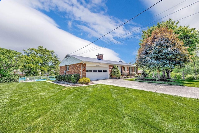 8714 Wuest Rd, Colerain Twp, OH 45251 - view of front of house with a chimney, brick siding, an attached garage, and asphalt driveway