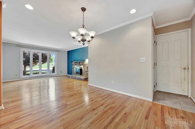 8714 Wuest Rd, Colerain Twp, OH 45251 - unfurnished living room with a chandelier, light wood finished floors, baseboards, ornamental molding, and recessed lighting