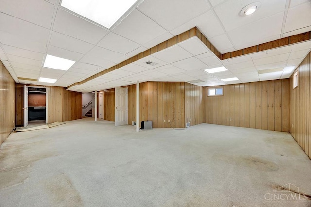 8714 Wuest Rd, Colerain Twp, OH 45251 - basement with stairs, a drop ceiling, carpet, and wood walls