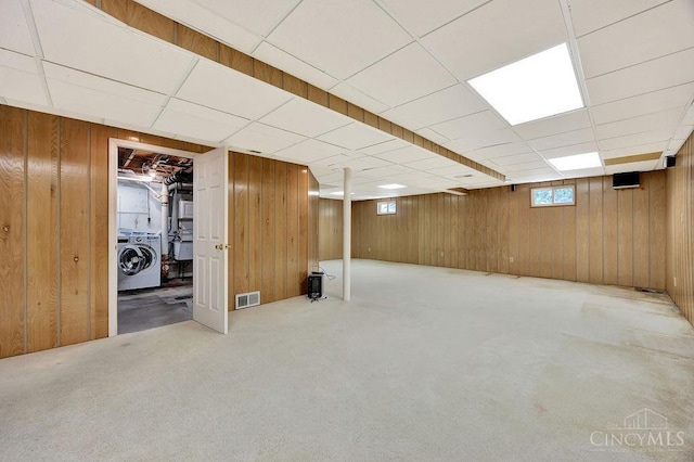 8714 Wuest Rd, Colerain Twp, OH 45251 - basement featuring washer / clothes dryer, wood walls, carpet floors, and a drop ceiling