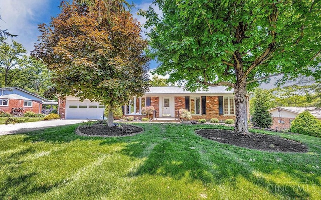 8714 Wuest Rd, Colerain Twp, OH 45251 - single story home featuring concrete driveway, a front yard, brick siding, and an attached garage
