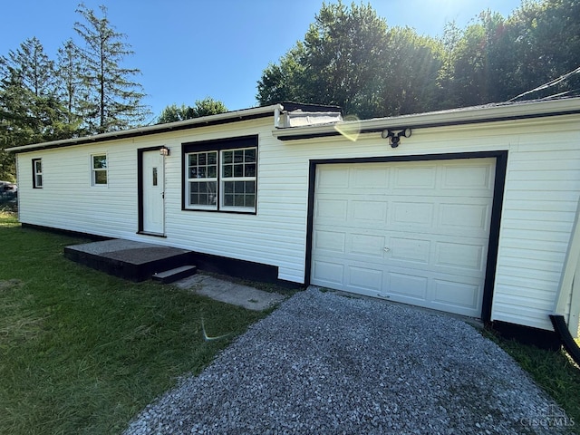 5776 State Route 132, Stonelick Twp, OH 45103 - view of front of home featuring asphalt driveway, a garage, and a front lawn