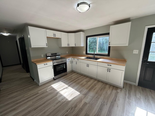 5776 State Route 132, Stonelick Twp, OH 45103 - kitchen featuring wood counters, stainless steel range with electric stovetop, a sink, and light wood-style flooring
