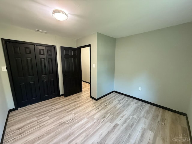 5776 State Route 132, Stonelick Twp, OH 45103 - unfurnished bedroom with light wood-style flooring, a closet, and baseboards