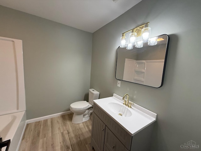 5776 State Route 132, Stonelick Twp, OH 45103 - bathroom featuring wood finished floors, vanity, toilet, a chandelier, and a bathtub