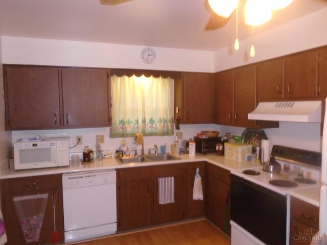 18 Blackwell Ct, Fairfield, OH 45014 - kitchen featuring white appliances, under cabinet range hood, a sink, light countertops, and brown cabinets