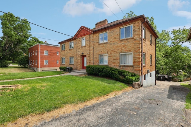 3366 Wunder Ave, Cincinnati, OH 45211 - view of front of property featuring a chimney, a front lawn, and brick siding
