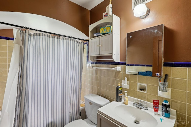 3366 Wunder Ave, Cincinnati, OH 45211 - bathroom with toilet, vanity, tile walls, shower / bath combination with curtain, and a wainscoted wall