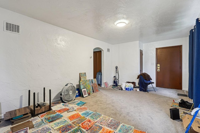 3366 Wunder Ave, Cincinnati, OH 45211 - game room featuring arched walkways, carpet, a textured wall, and a textured ceiling